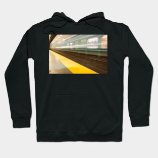 Platform with yellow line railway tracks blurred in motion blur aws train passes. Hoodie